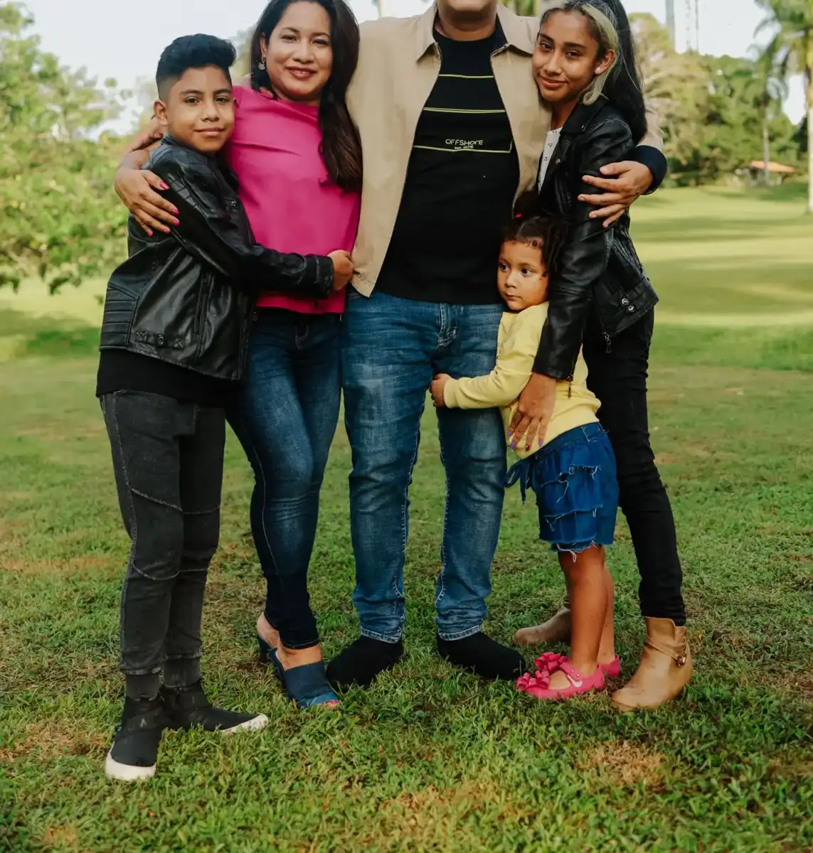 Family smiling outside together